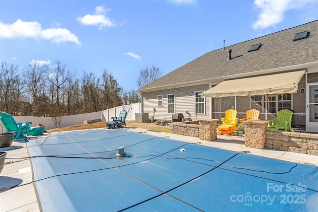 view of swimming pool featuring cooling unit and a patio