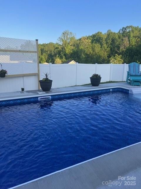 view of swimming pool with a water view