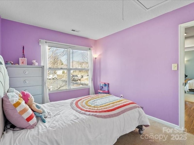 carpeted bedroom with a textured ceiling