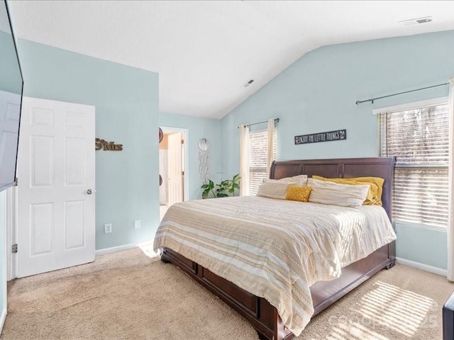 carpeted bedroom featuring lofted ceiling