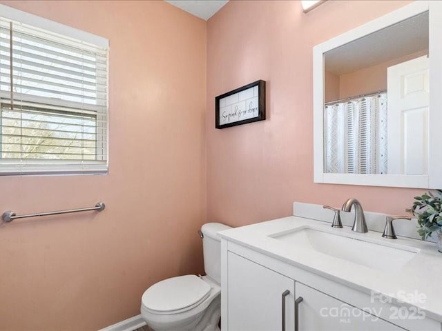 bathroom with vanity and toilet