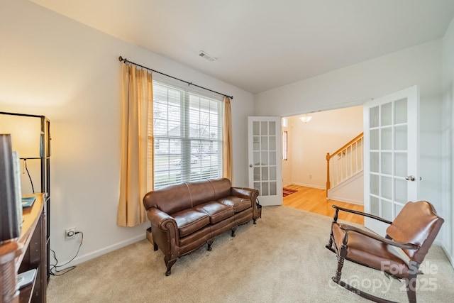 sitting room with light carpet and french doors