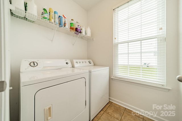 laundry room featuring independent washer and dryer and light tile patterned floors