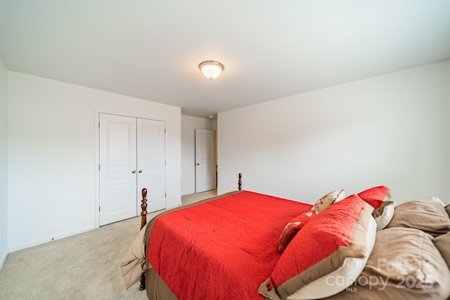 bedroom featuring a closet and light carpet