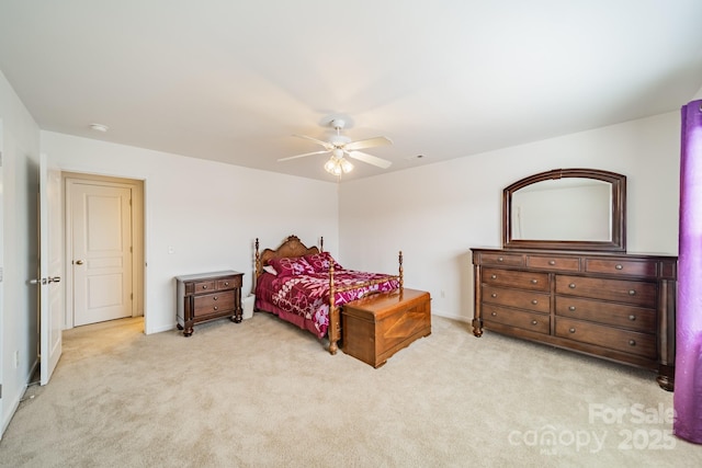 bedroom with ceiling fan and light colored carpet