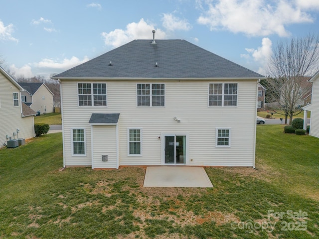 back of house featuring cooling unit, a lawn, and a patio