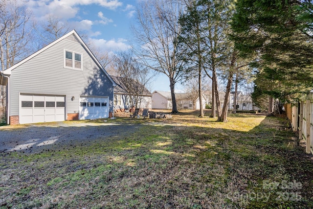 view of home's exterior featuring a garage and a lawn