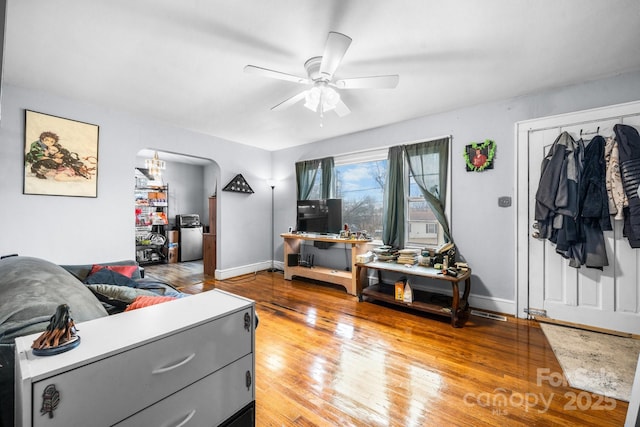 living room with ceiling fan and wood-type flooring