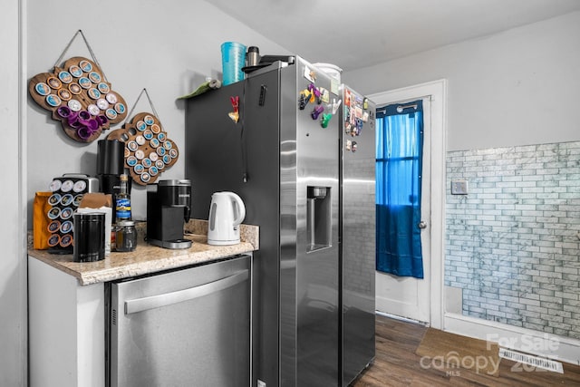 kitchen with fridge and dark hardwood / wood-style flooring