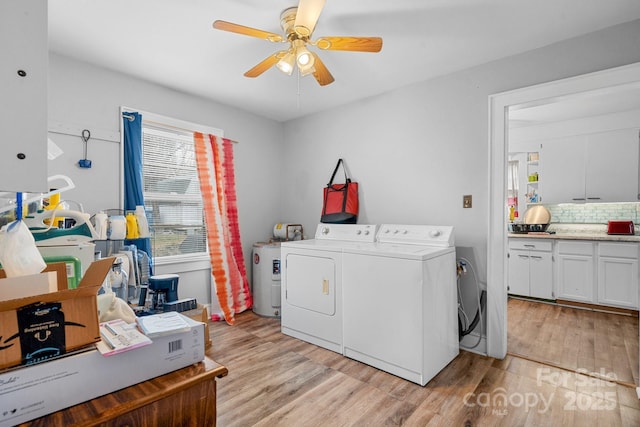 washroom featuring ceiling fan, washing machine and clothes dryer, and light wood-type flooring