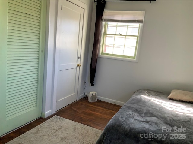 bedroom with dark hardwood / wood-style floors