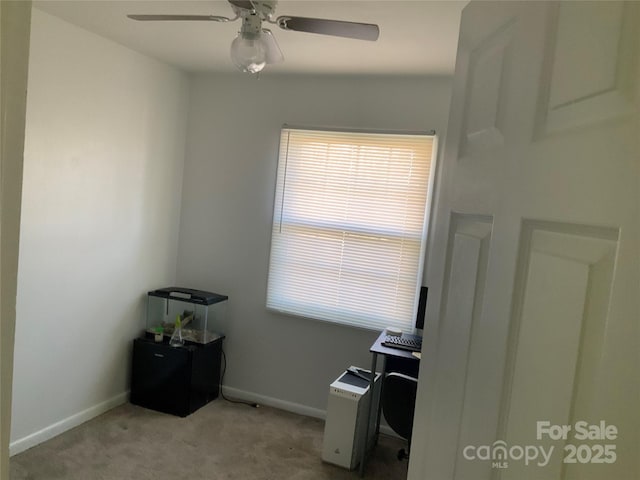 carpeted home office with ceiling fan