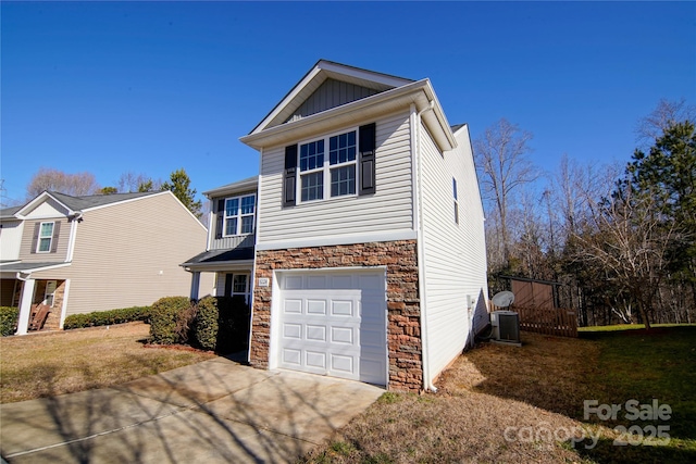 view of front of property with a garage and central air condition unit