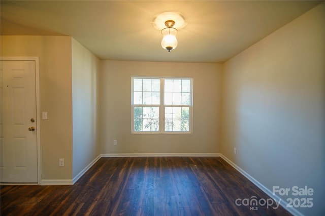 spare room featuring dark hardwood / wood-style flooring