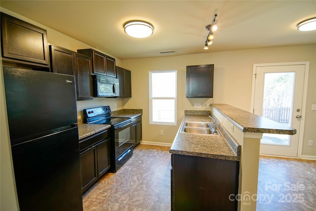 kitchen with sink, dark brown cabinets, black appliances, and a healthy amount of sunlight