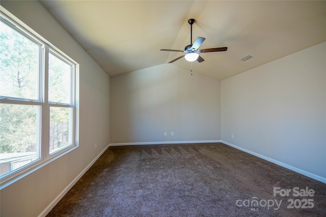 carpeted spare room with vaulted ceiling and ceiling fan