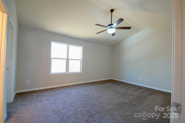 carpeted spare room featuring ceiling fan and vaulted ceiling