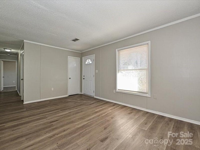 entryway with crown molding, dark hardwood / wood-style flooring, and a textured ceiling