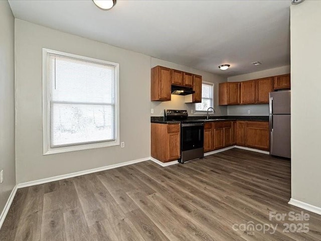 kitchen featuring stainless steel appliances, sink, and dark hardwood / wood-style flooring