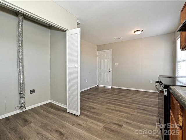 interior space featuring dark hardwood / wood-style floors and electric range oven