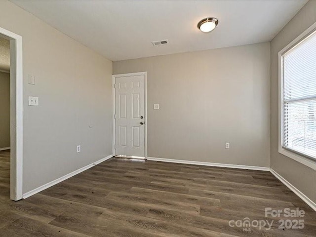 spare room featuring dark hardwood / wood-style floors