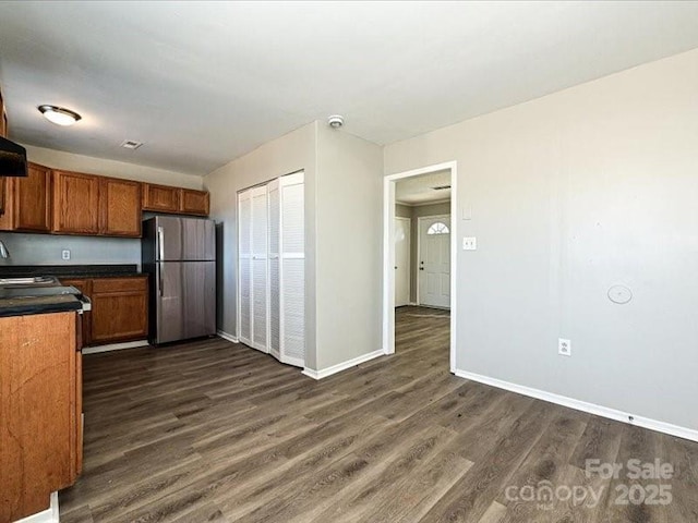 kitchen featuring dark wood-type flooring and stainless steel refrigerator