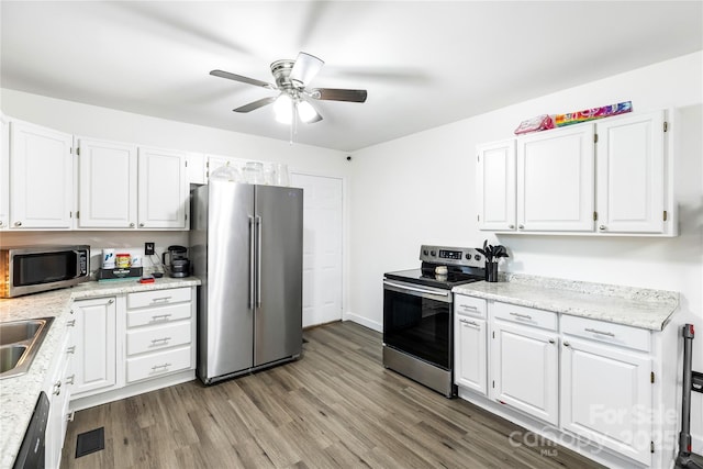 kitchen with white cabinetry, ceiling fan, appliances with stainless steel finishes, and light wood-type flooring