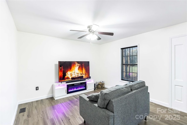 living room with hardwood / wood-style flooring and ceiling fan