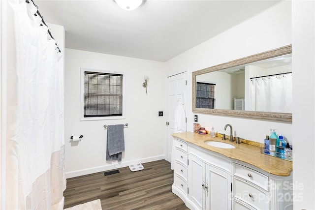 bathroom featuring vanity and hardwood / wood-style floors