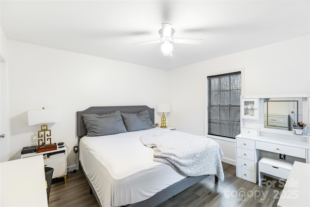 bedroom with dark hardwood / wood-style flooring and ceiling fan