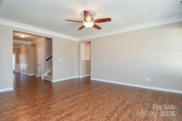 empty room with dark hardwood / wood-style flooring, ornamental molding, and ceiling fan