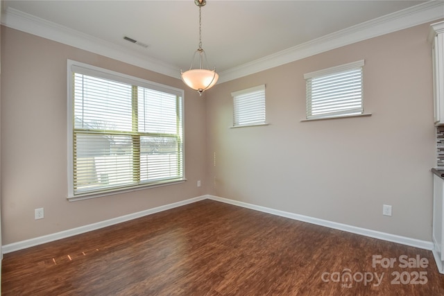 empty room with ornamental molding and dark hardwood / wood-style flooring