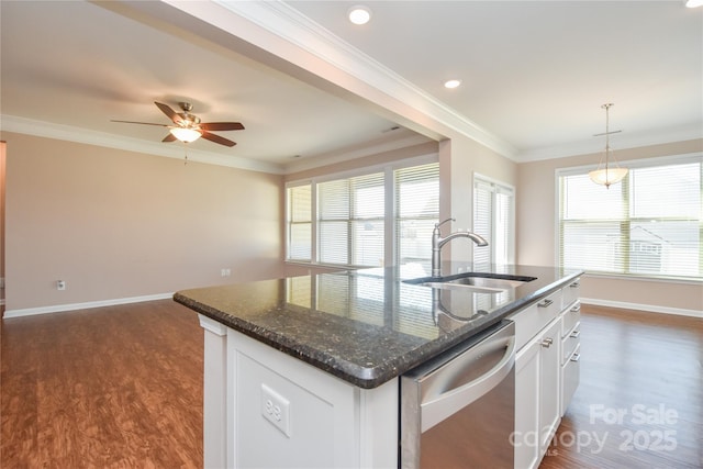 kitchen with sink, an island with sink, white cabinets, stainless steel dishwasher, and dark stone counters