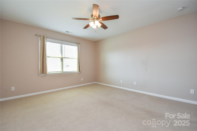 spare room with light carpet and ceiling fan