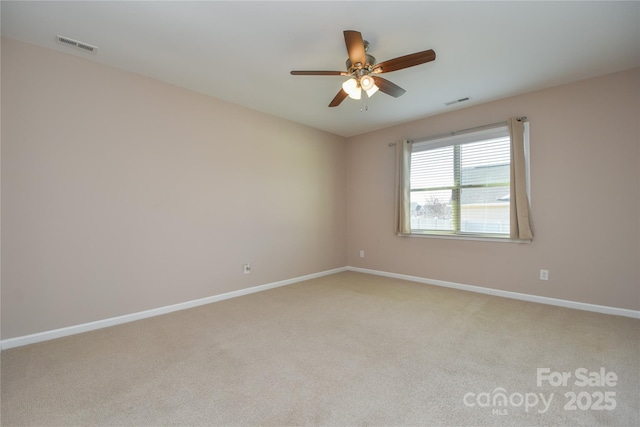 carpeted spare room featuring ceiling fan