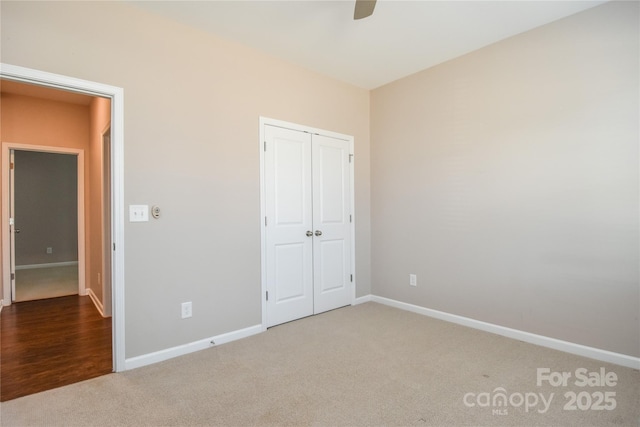 unfurnished bedroom featuring ceiling fan, a closet, and carpet