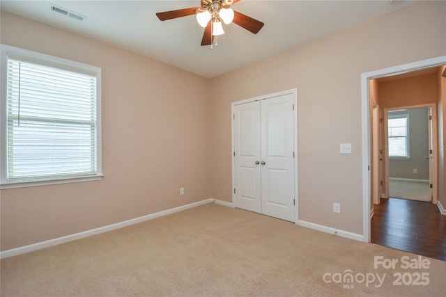 unfurnished bedroom featuring ceiling fan, carpet floors, and a closet