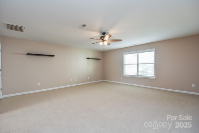 spare room with ceiling fan and light colored carpet