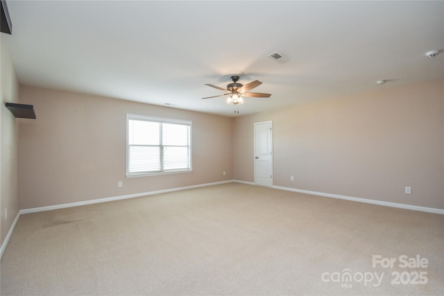 unfurnished room with light colored carpet and ceiling fan