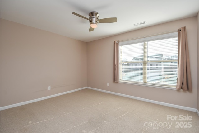 empty room with ceiling fan and carpet