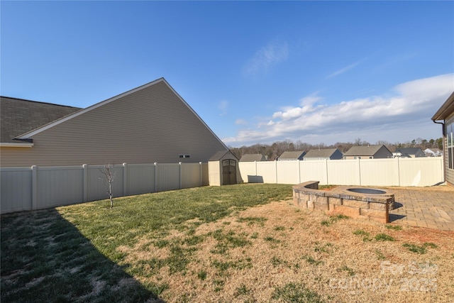 view of yard featuring a patio area and a storage shed