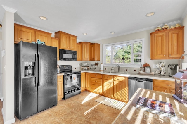 kitchen featuring ornamental molding, sink, and black appliances