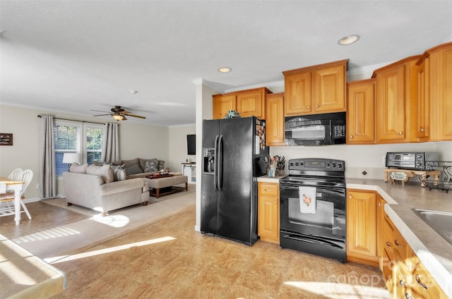 kitchen with ornamental molding, ceiling fan, and black appliances