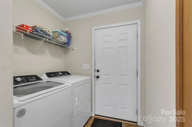 washroom featuring ornamental molding and washing machine and clothes dryer