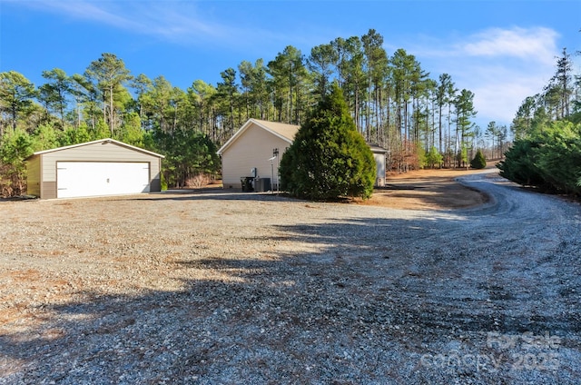 exterior space with an outbuilding and a garage