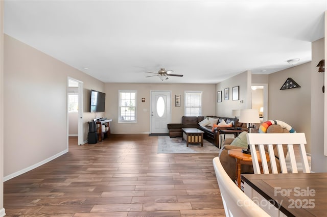 living room with wood-type flooring and ceiling fan