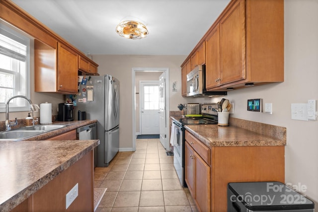 kitchen featuring appliances with stainless steel finishes, sink, and light tile patterned floors