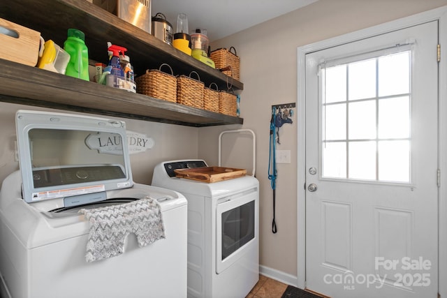 washroom featuring tile patterned flooring, a healthy amount of sunlight, and washer and dryer