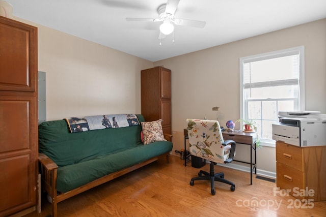 home office with ceiling fan and light wood-type flooring