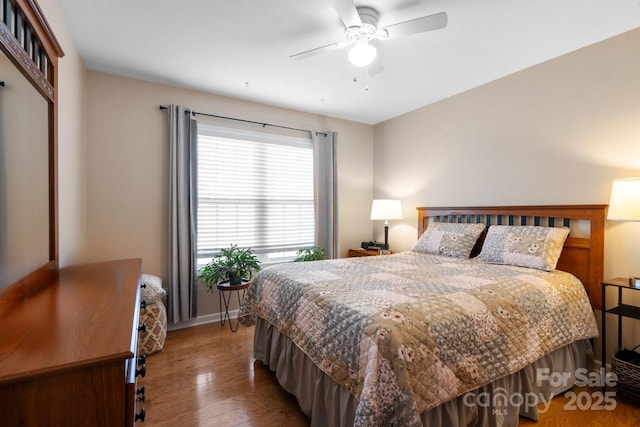 bedroom featuring hardwood / wood-style flooring and ceiling fan